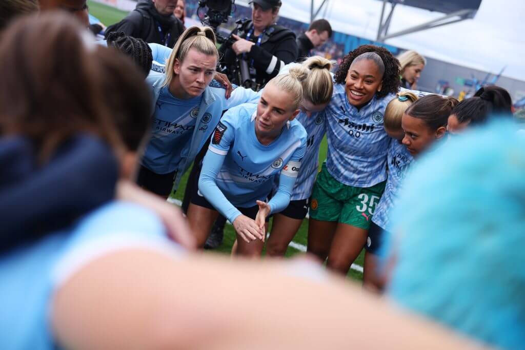 Manchester City women's soccer players celebrating their Women's Super League championship title victory