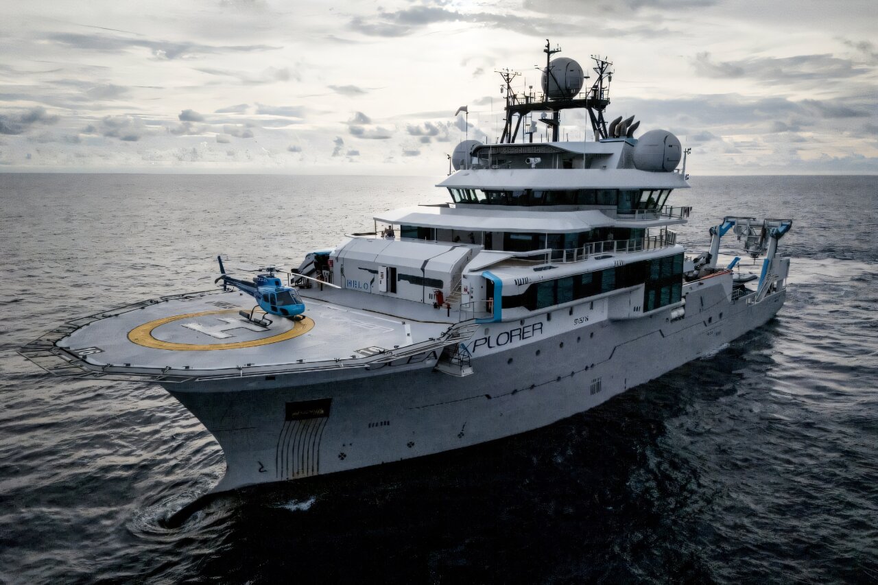 High-tech research vessel OceanXplorer with futuristic mission control room and scientific equipment onboard