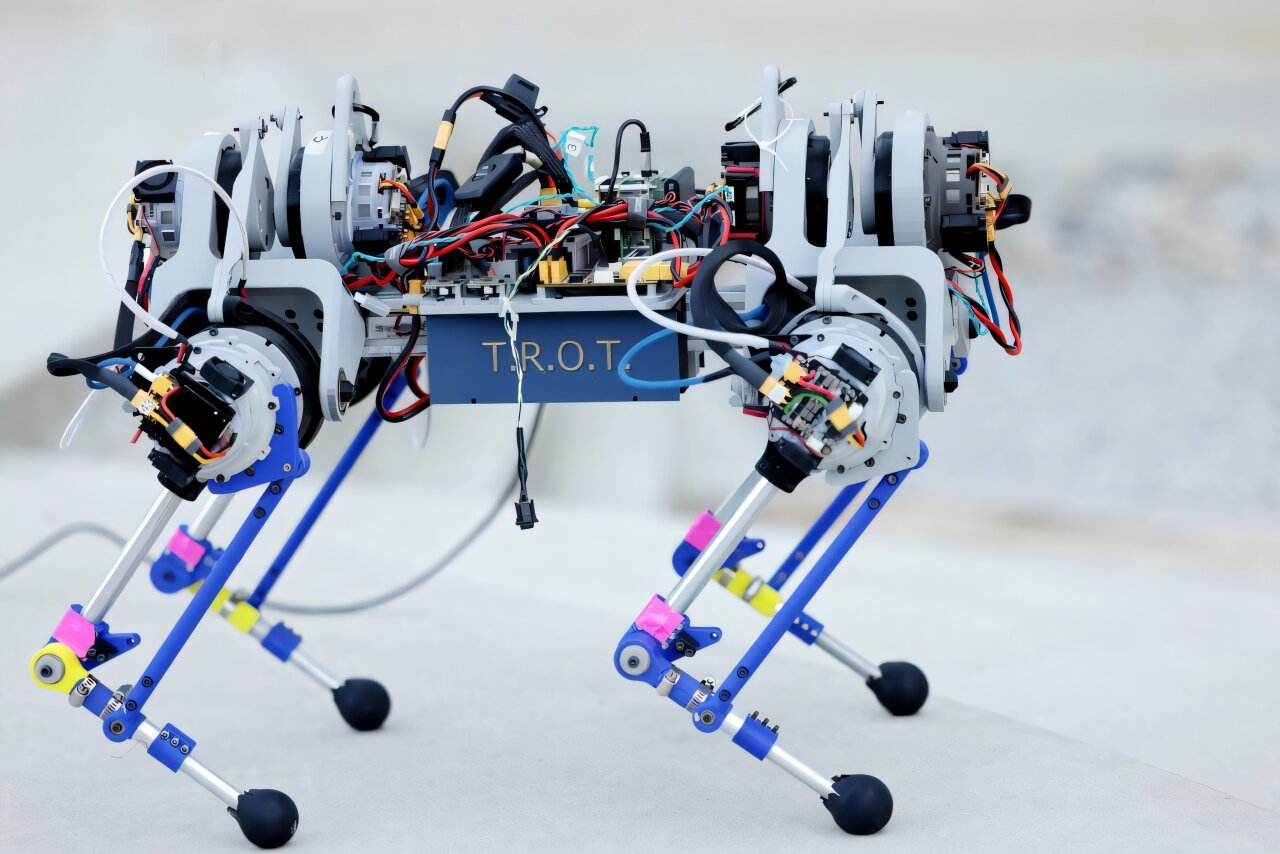 Modular robot with adjustable legs made from 3D-printed white parts on laboratory floor