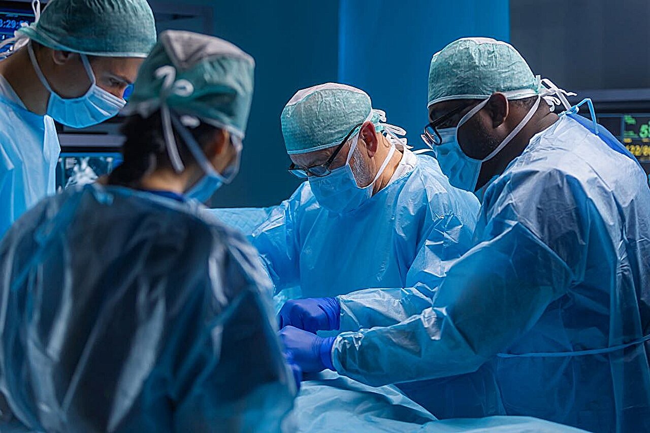 Surgical team performing advanced coronary artery bypass heart surgery in modern operating room