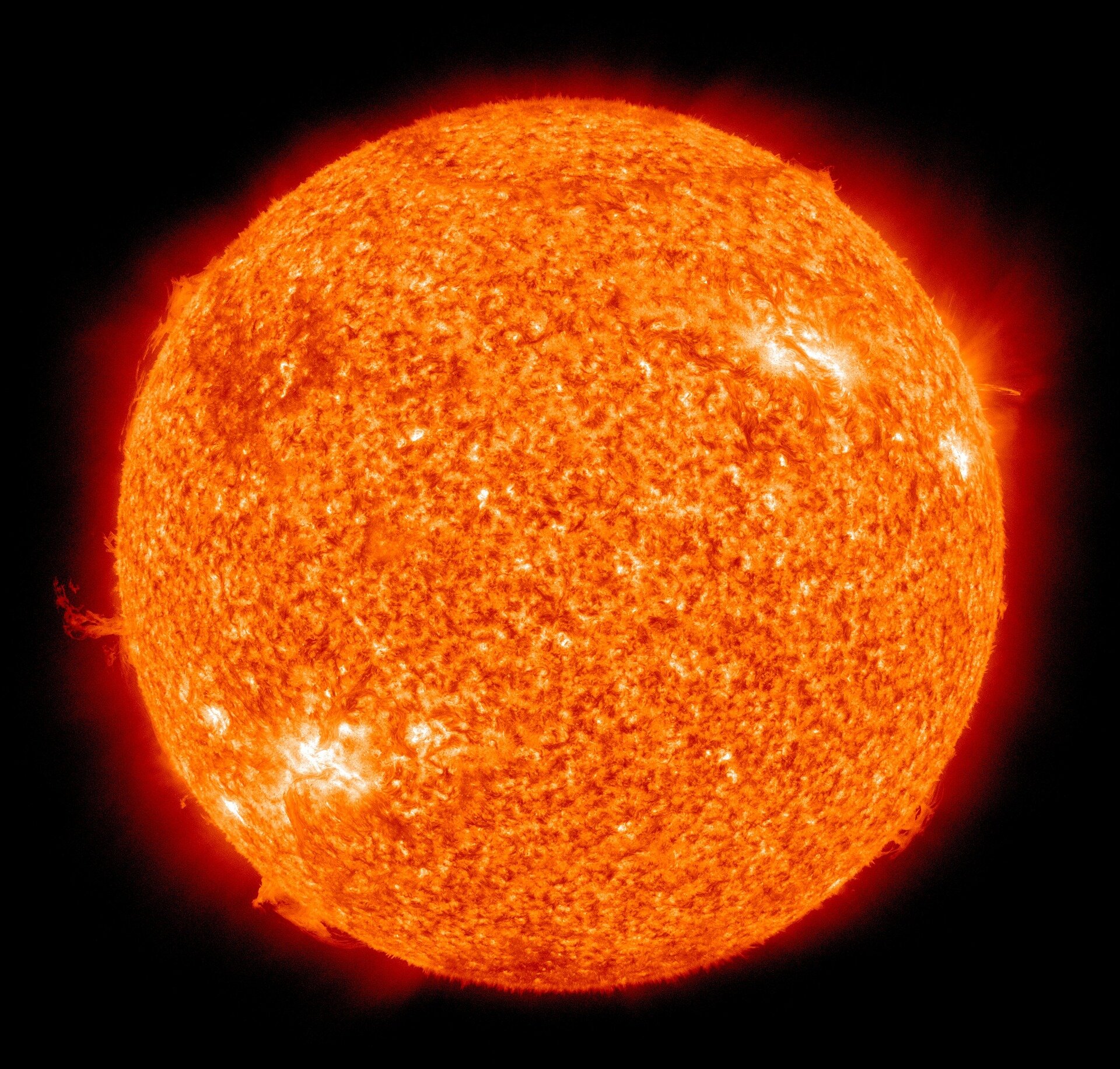 Yellow glowing solar corona with dark orange sun disk showing plasma prominence eruptions