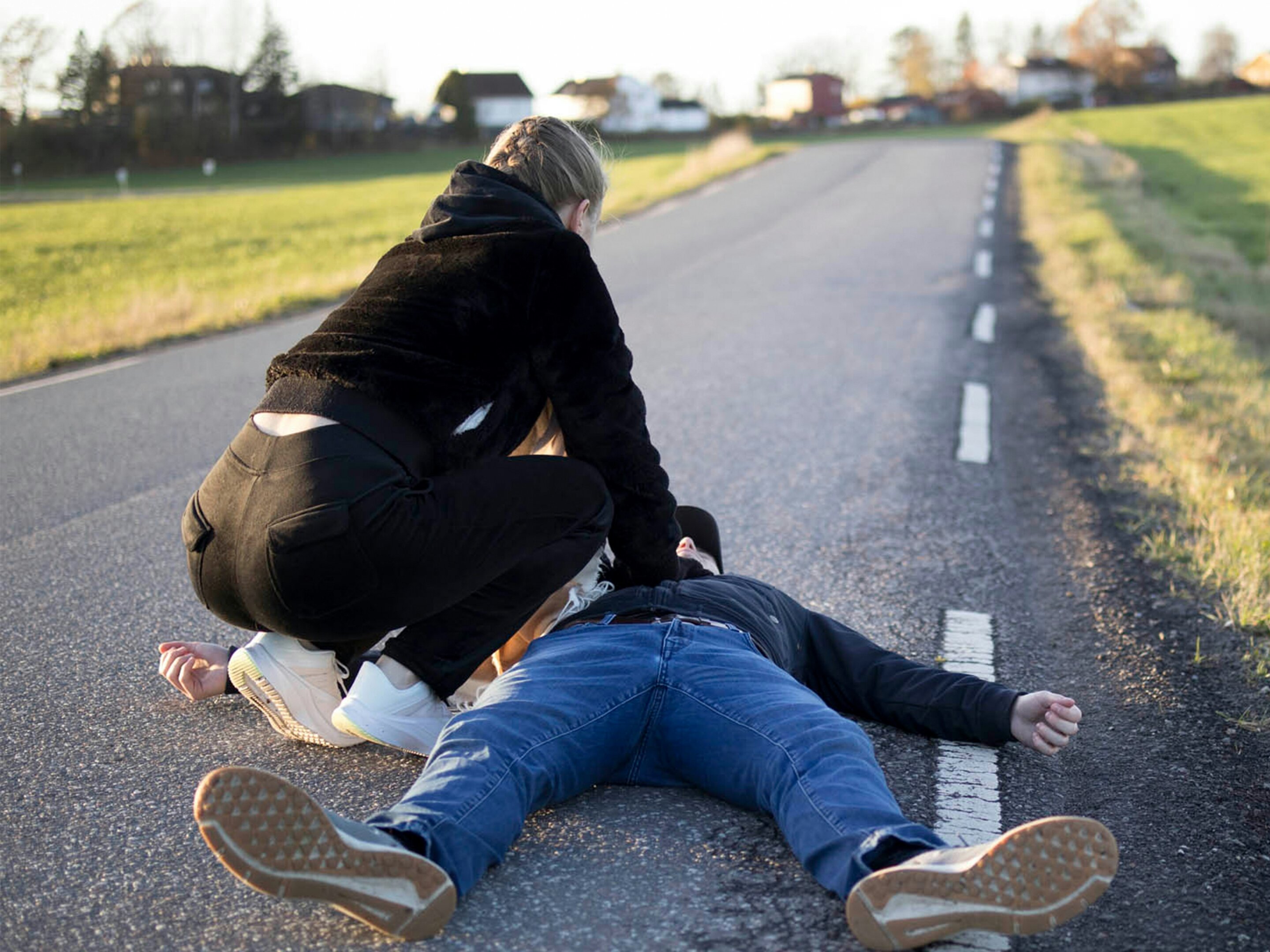 Person performing chest compressions during CPR training on practice dummy