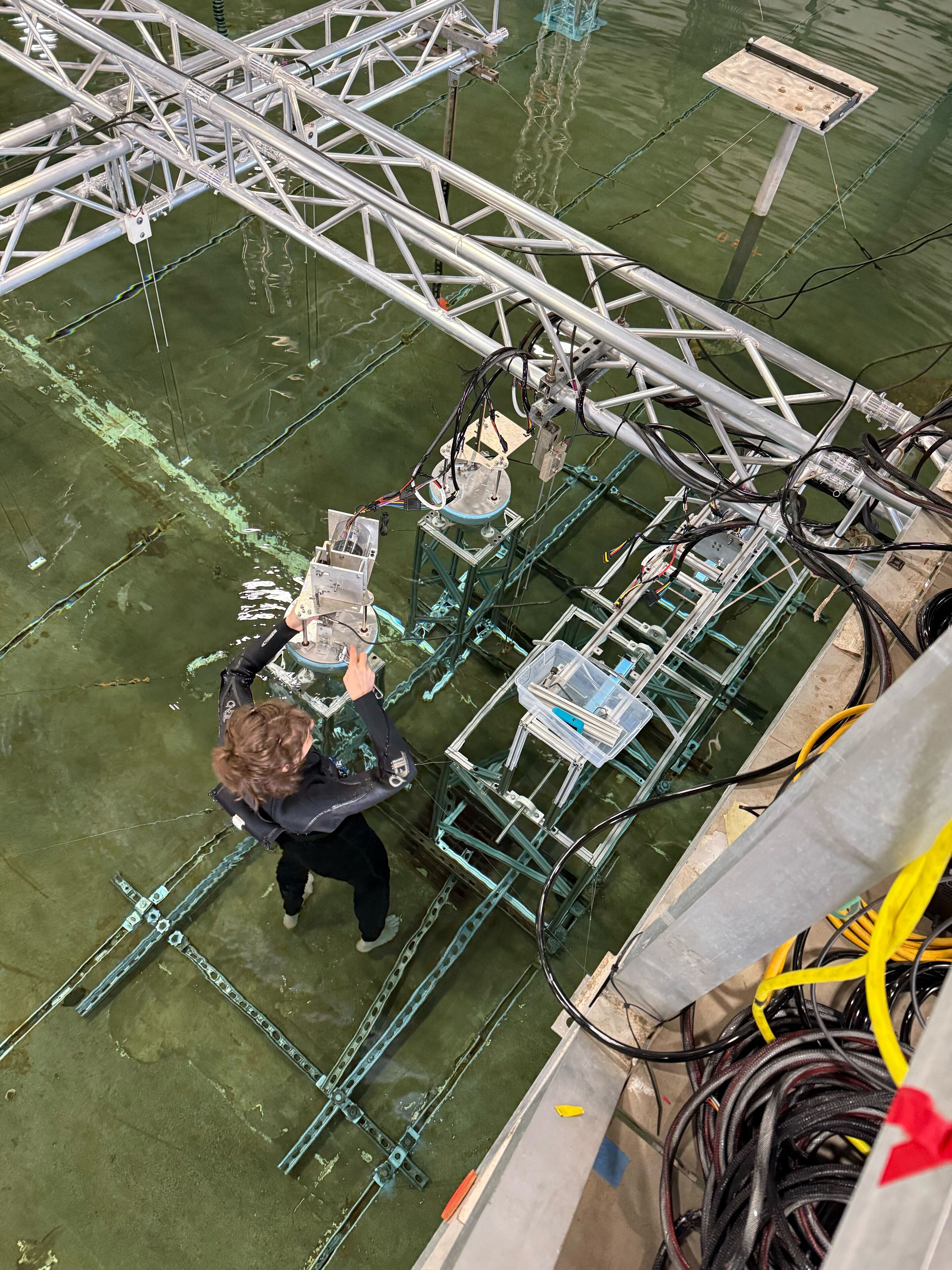 Small-scale wave energy converter prototype being tested in large wave research laboratory tank