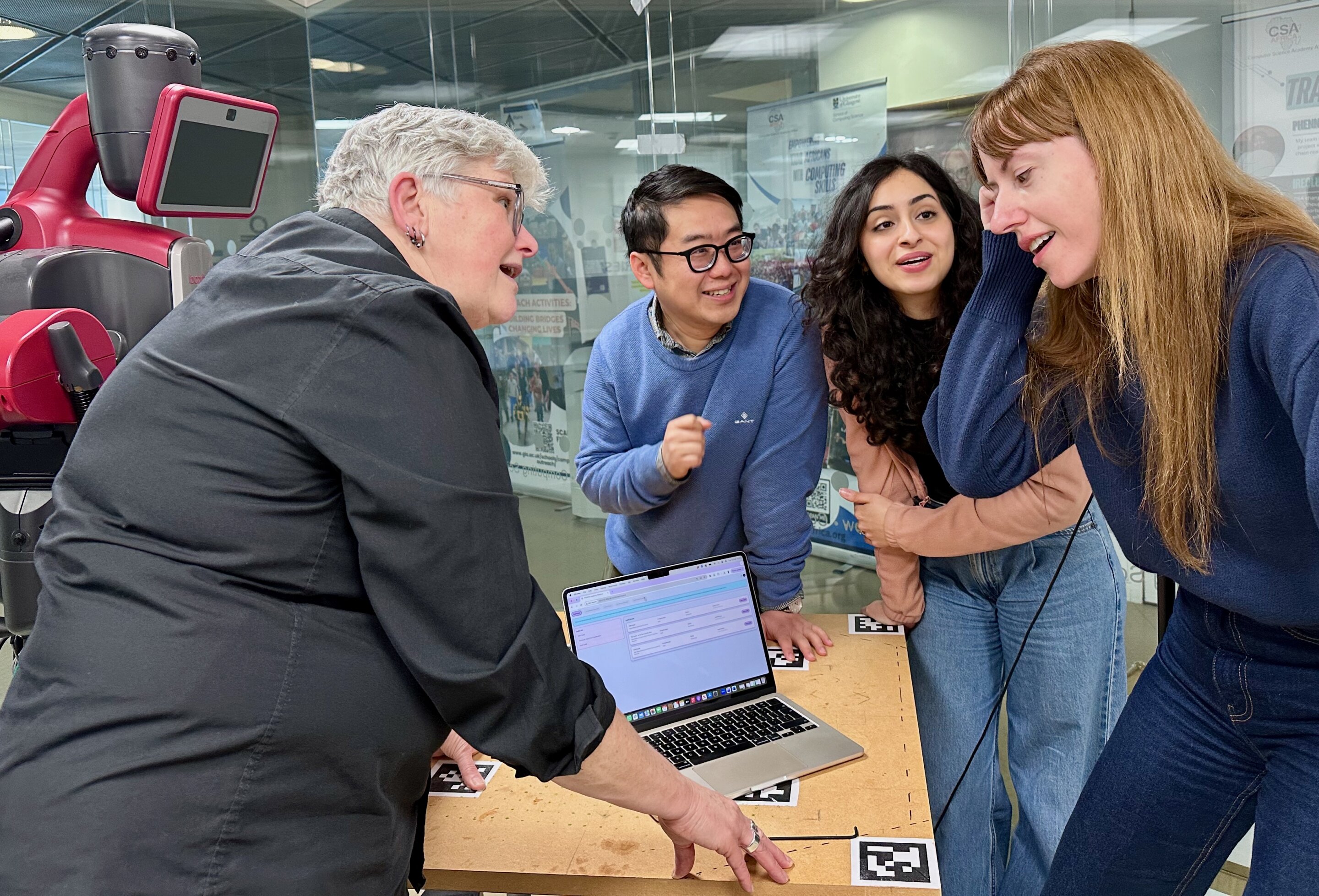 Diverse group of people working together on computers auditing artificial intelligence systems