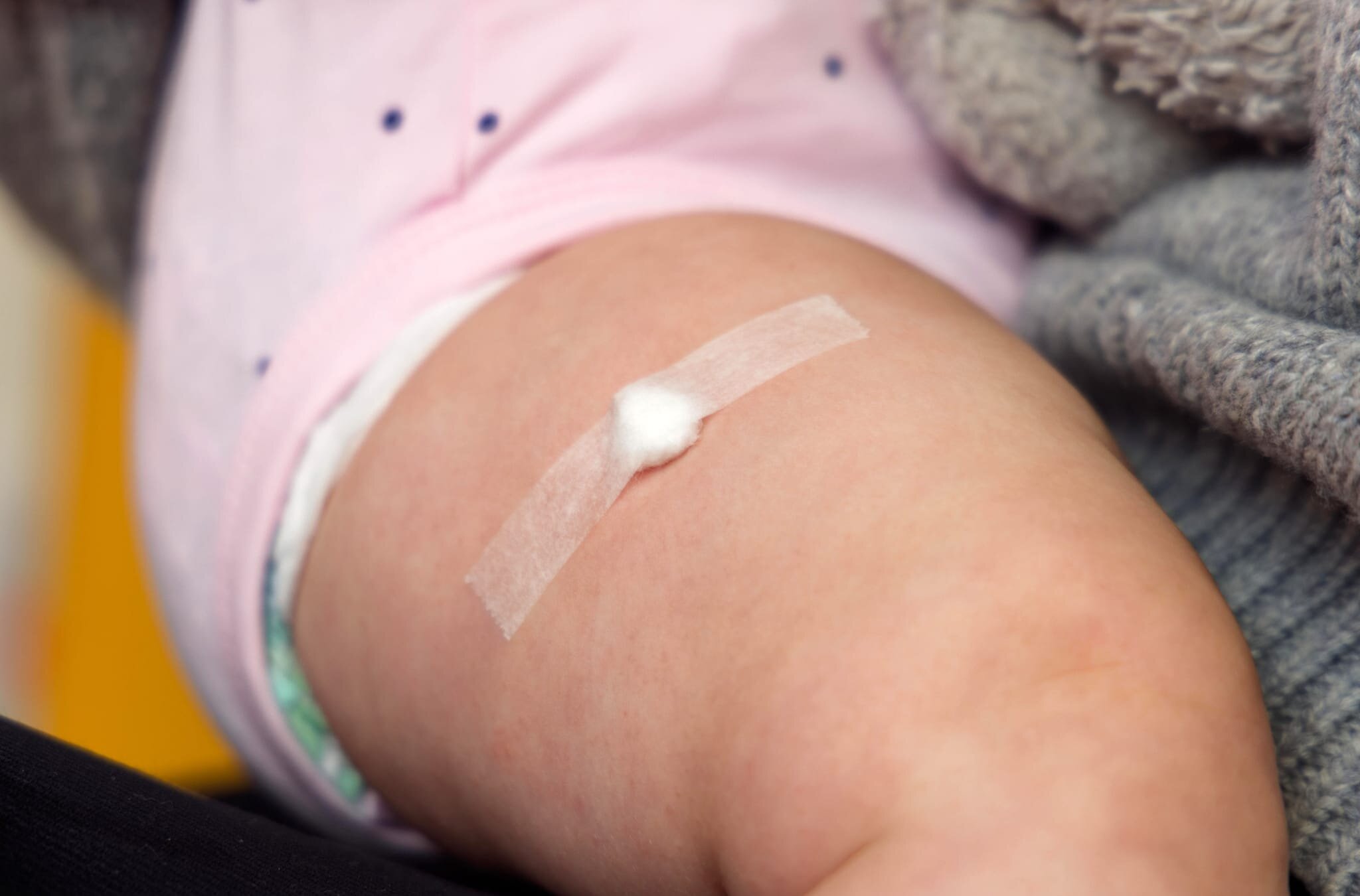 Parent holding smartphone receiving vaccination reminder text message from doctor's office