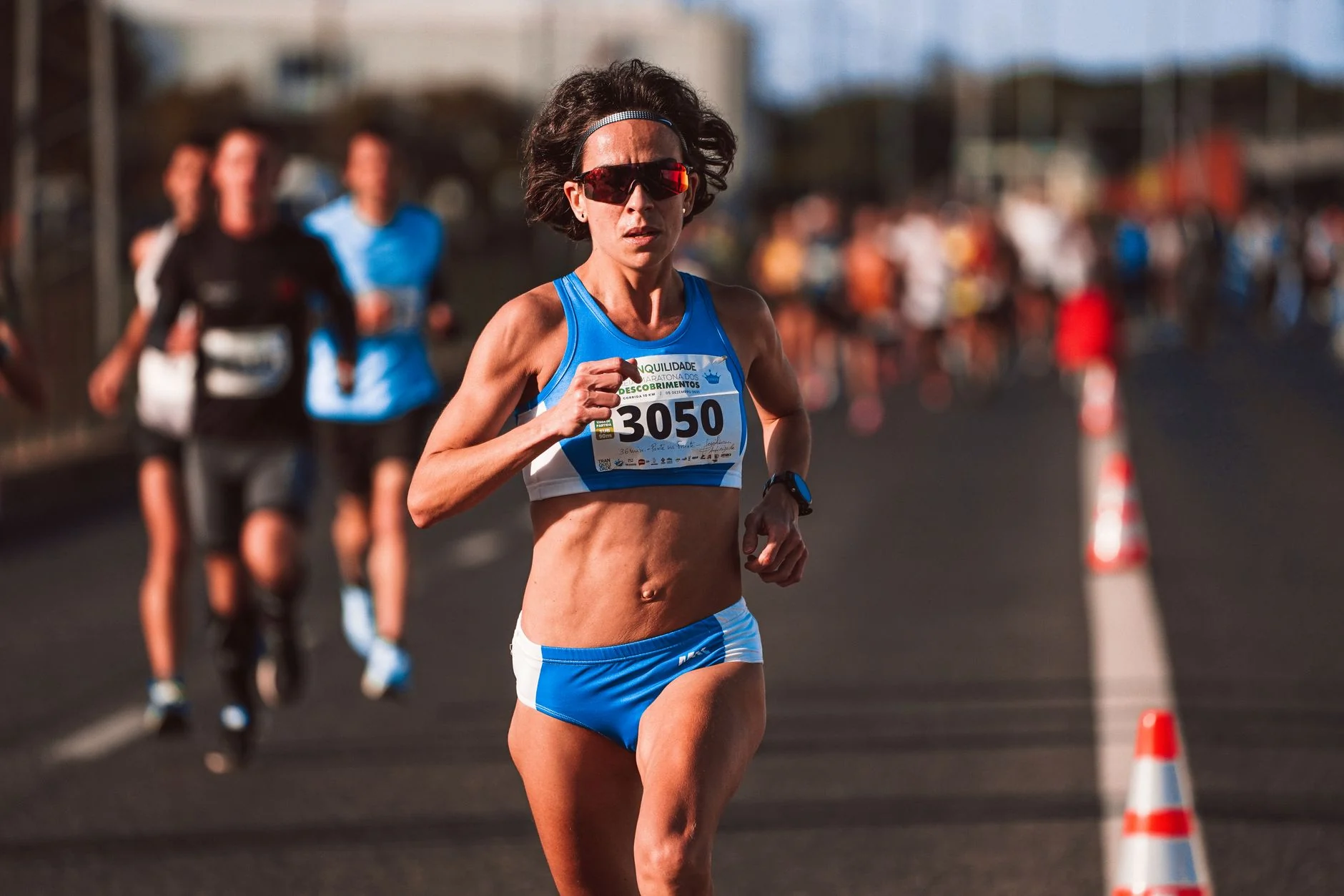 Ethiopian marathoner Tigst Assefa crossing finish line at London Marathon in running gear