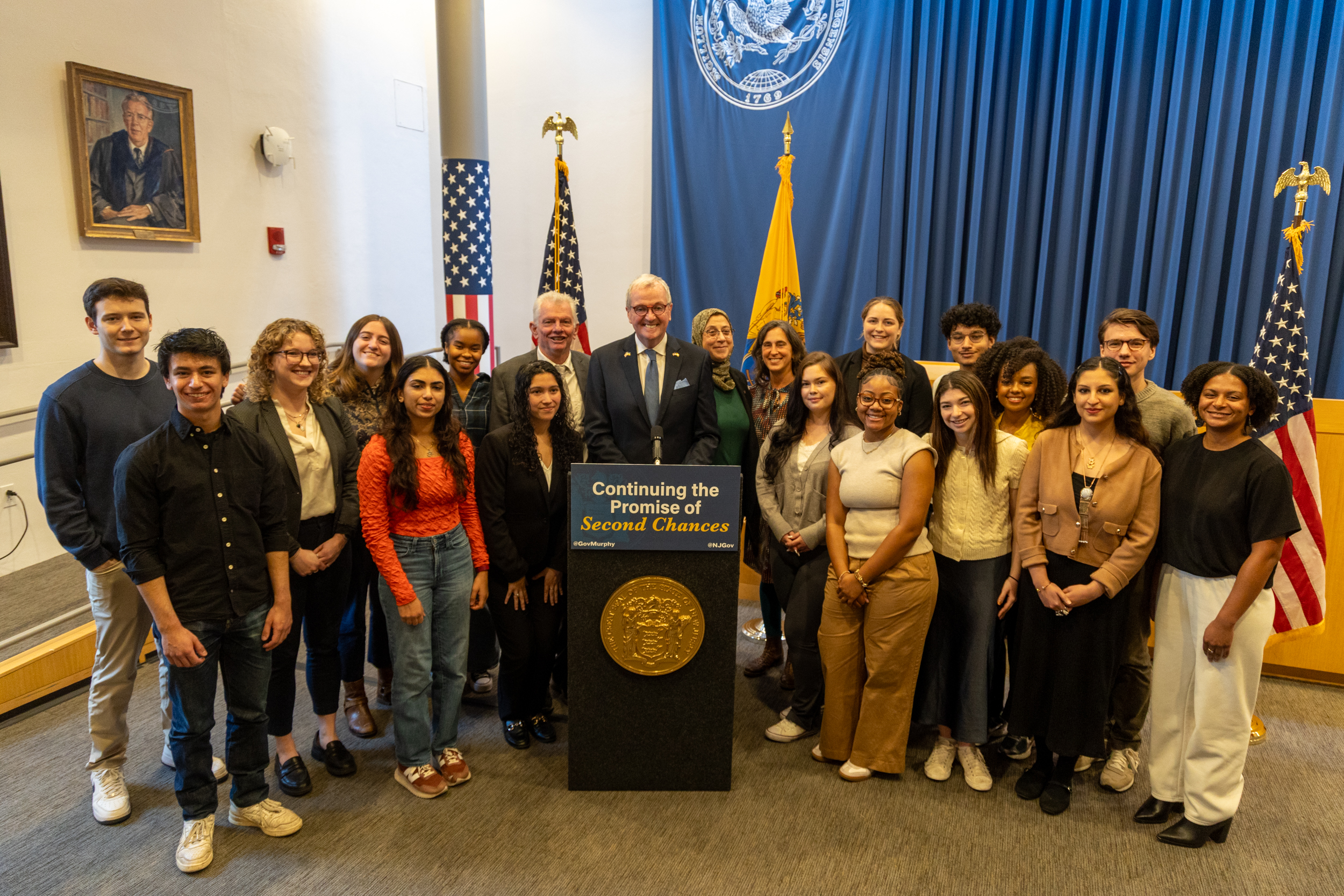 Princeton students and faculty pose with former New Jersey Governor Phil Murphy during clemency announcement ceremony