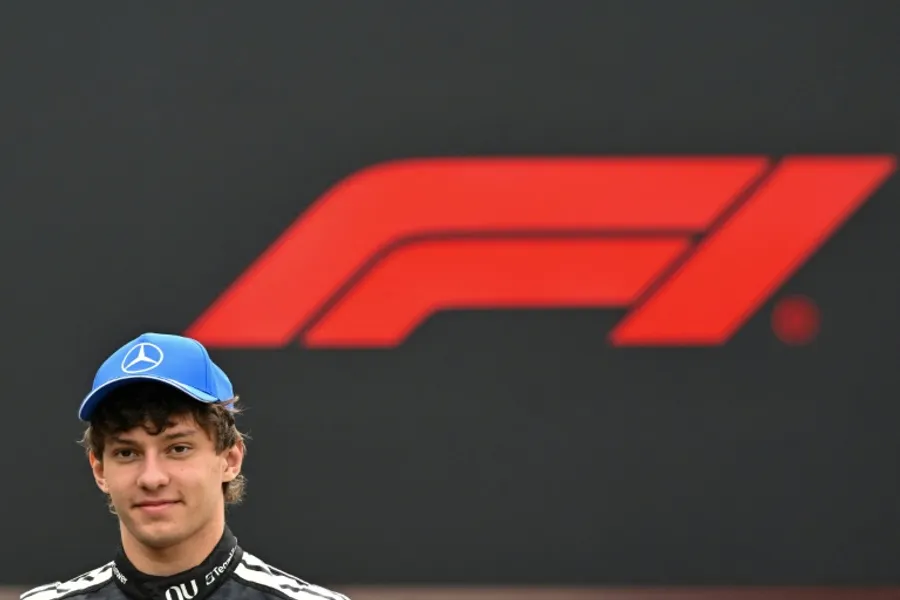 Young Formula One driver Kimi Antonelli in Mercedes racing suit celebrating his first grand prix victory