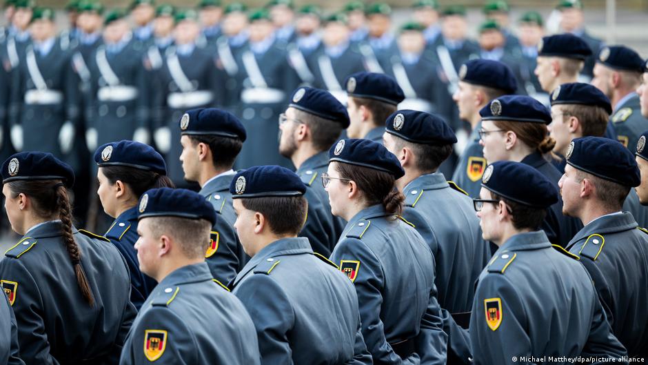 ** German Chancellor Friedrich Merz speaking with military and police personnel at Berlin reception event