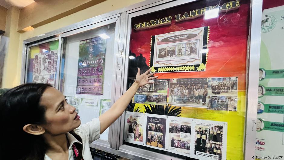 Filipino teacher leading German language lesson in public high school classroom in Philippines
