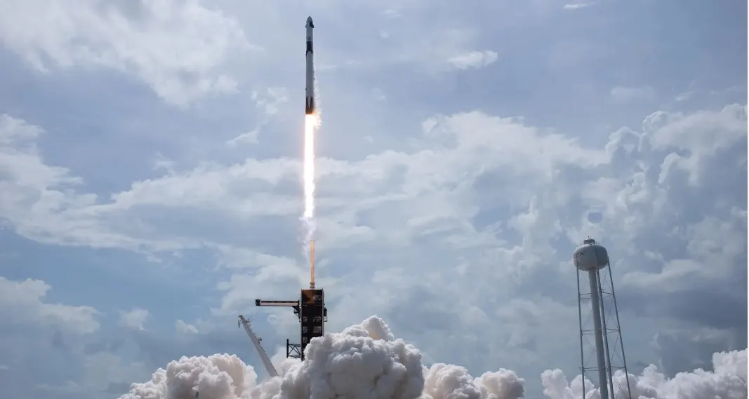 SpaceX rocket on launch pad with Louisiana landscape in background at sunrise
