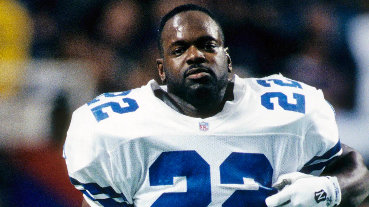 Emmitt Smith in Dallas Cowboys uniform number 22 speaking with his son EJ