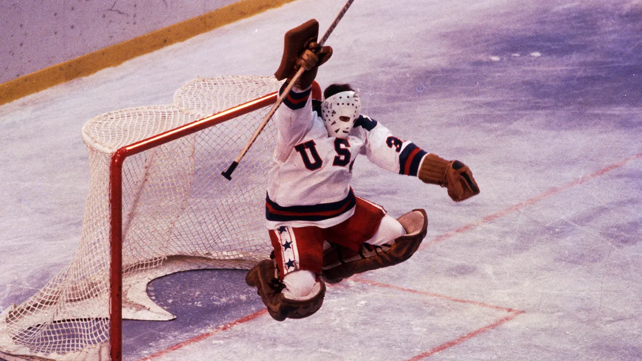 Jim Craig celebrating on ice after Team USA's historic 1980 Olympic hockey victory