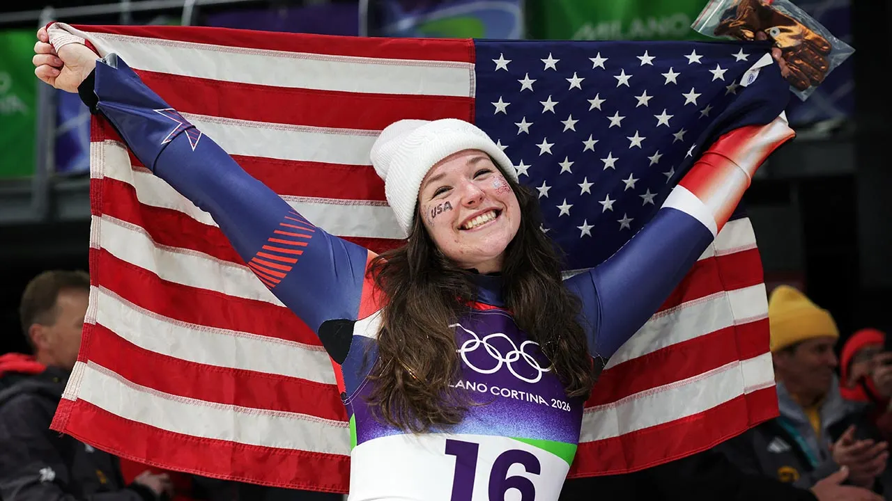 Ashley Farquharson celebrates with American flag after winning Olympic bronze medal in luge