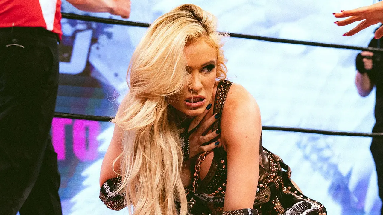 Scarlett Bordeaux celebrates victory in Major League Wrestling wrestling ring with championship gestures