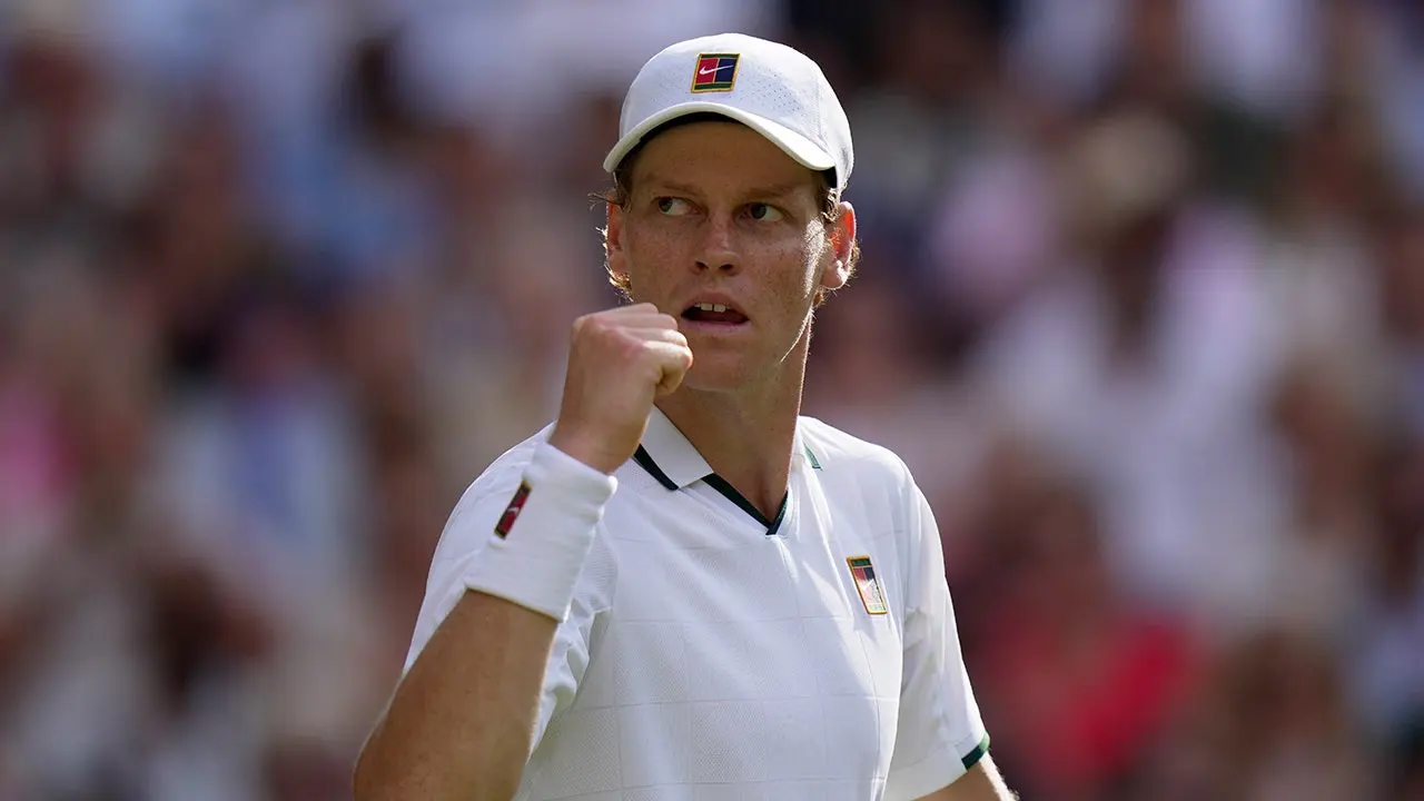 Jannik Sinner celebrates winning a point during Wimbledon semifinal match against Novak Djokovic