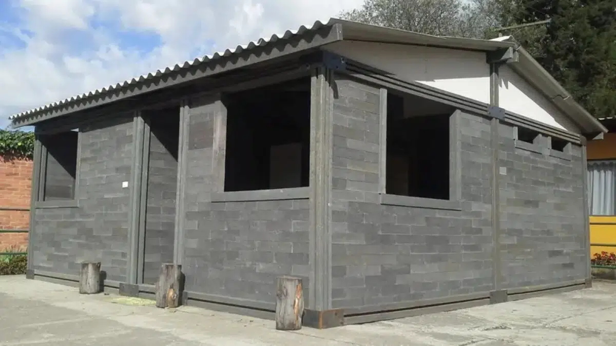 Modular plastic construction blocks being assembled into walls for affordable housing in Colombia