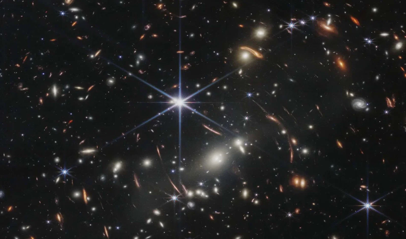Curved arc of light from distant galaxy warped by gravitational lensing in space telescope image