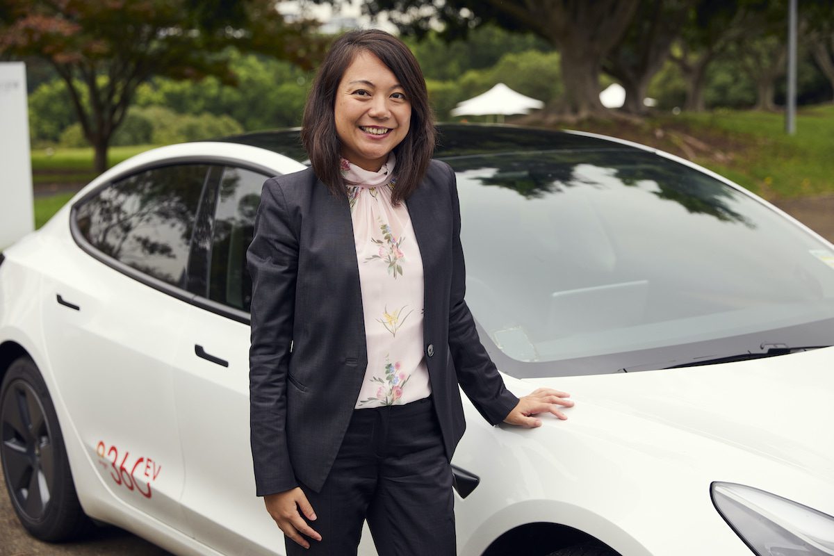 Electric vehicle charging at home station with power cord connected to car port