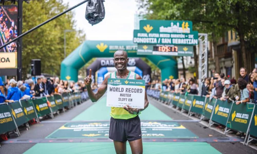 Kenyan runner Mark Kiptoo celebrating after breaking half marathon world record at age 50