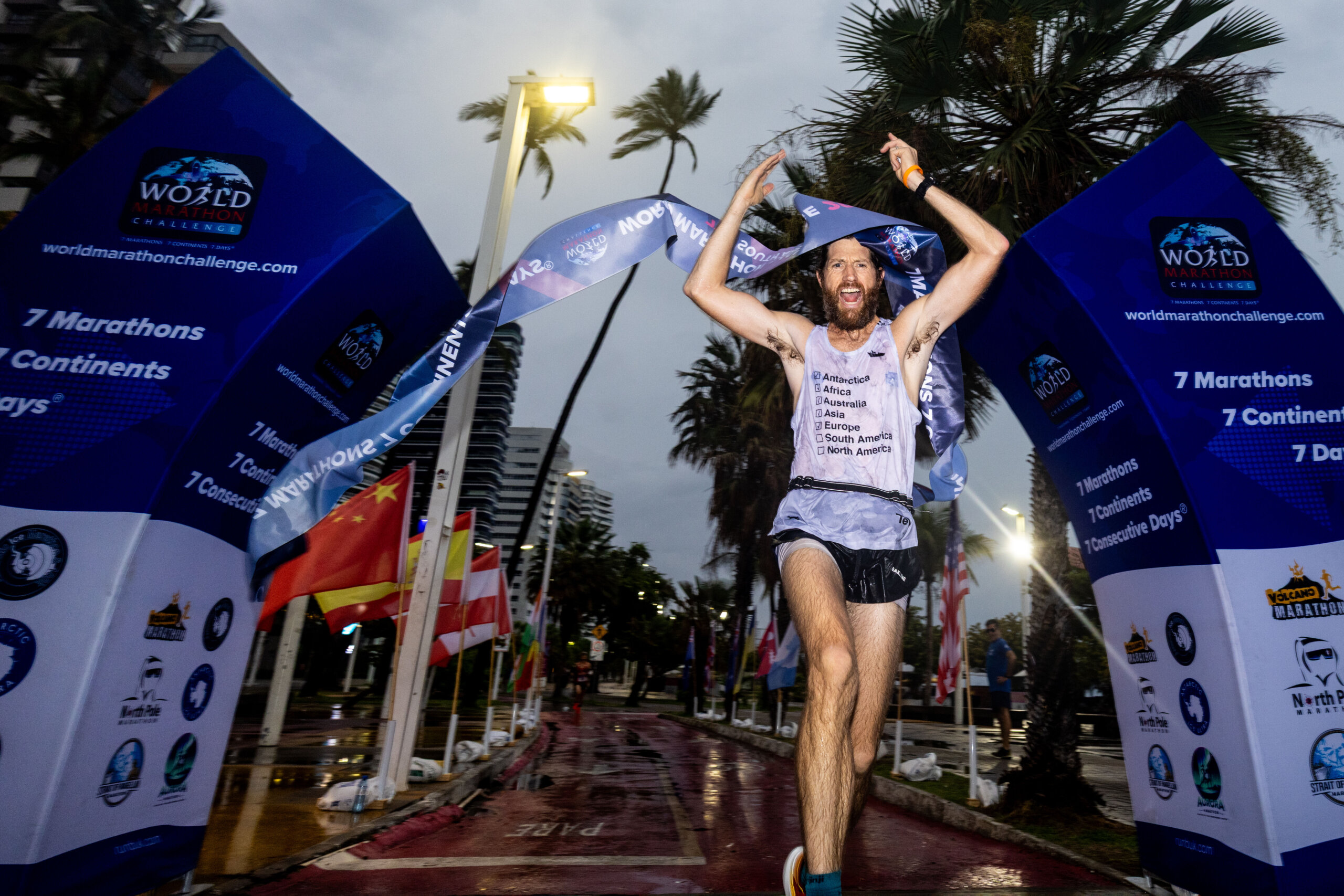 Michael Wardian running an ultramarathon wearing race gear and hydration pack across multiple continents