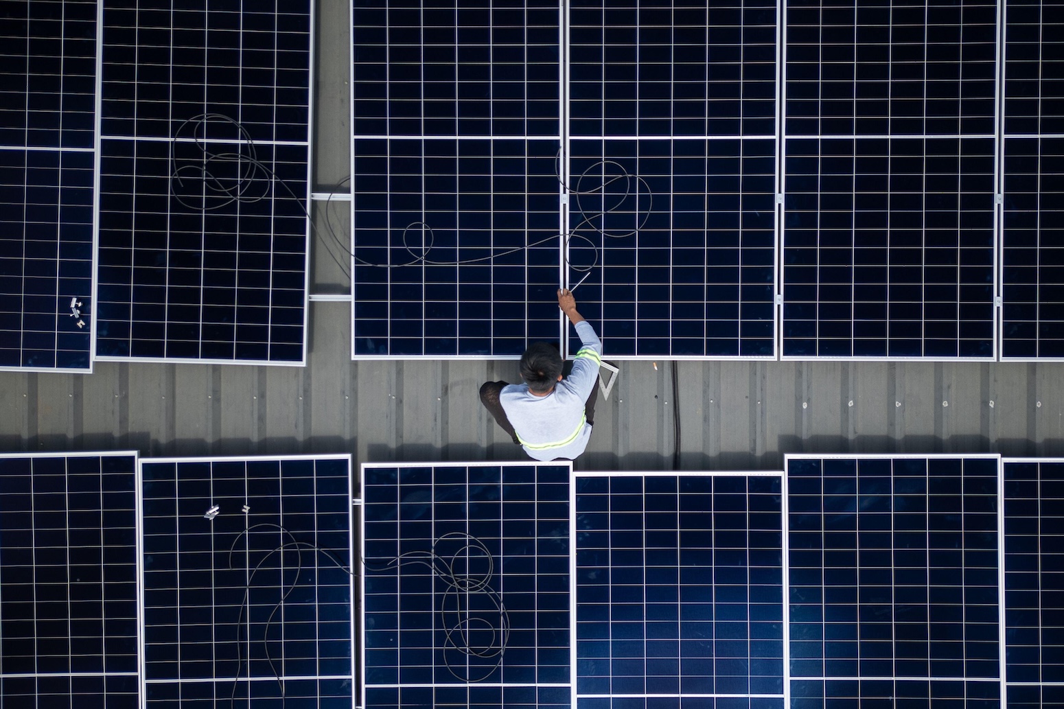 ** Solar panel installation against blue sky showing renewable energy infrastructure expansion