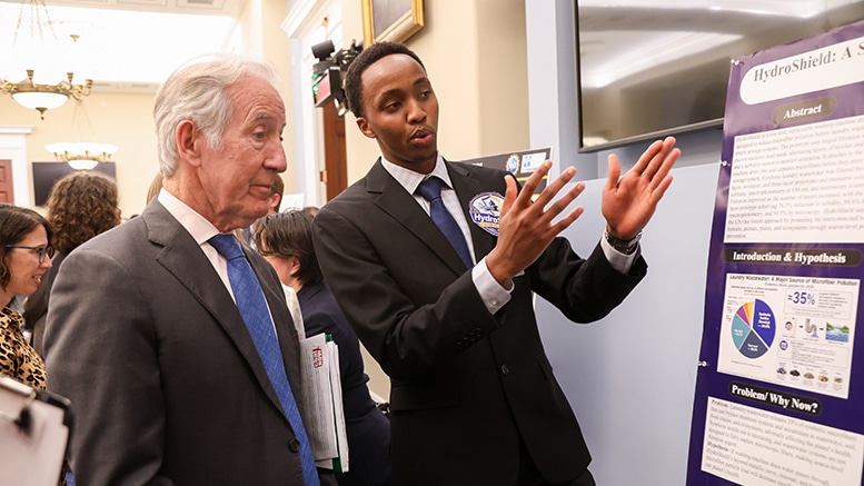 Community college students presenting washing machine microplastic filter innovation to congressman at Capitol Hill poster session