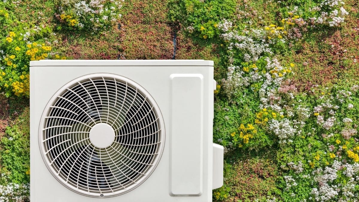 HVAC technician installing modern heat pump system in residential home in Ventura County