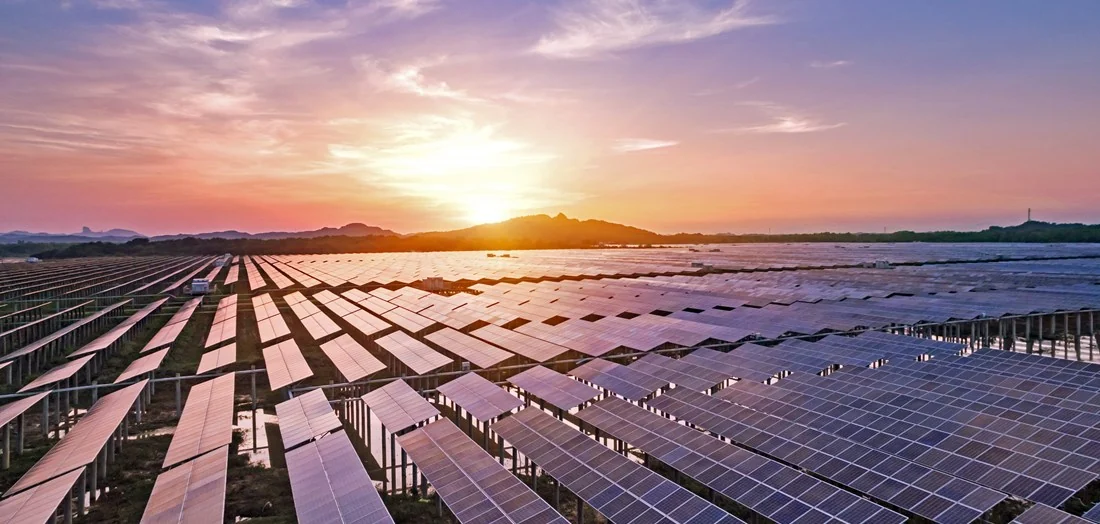 Solar panels and wind turbines generating clean electricity across Australian landscape