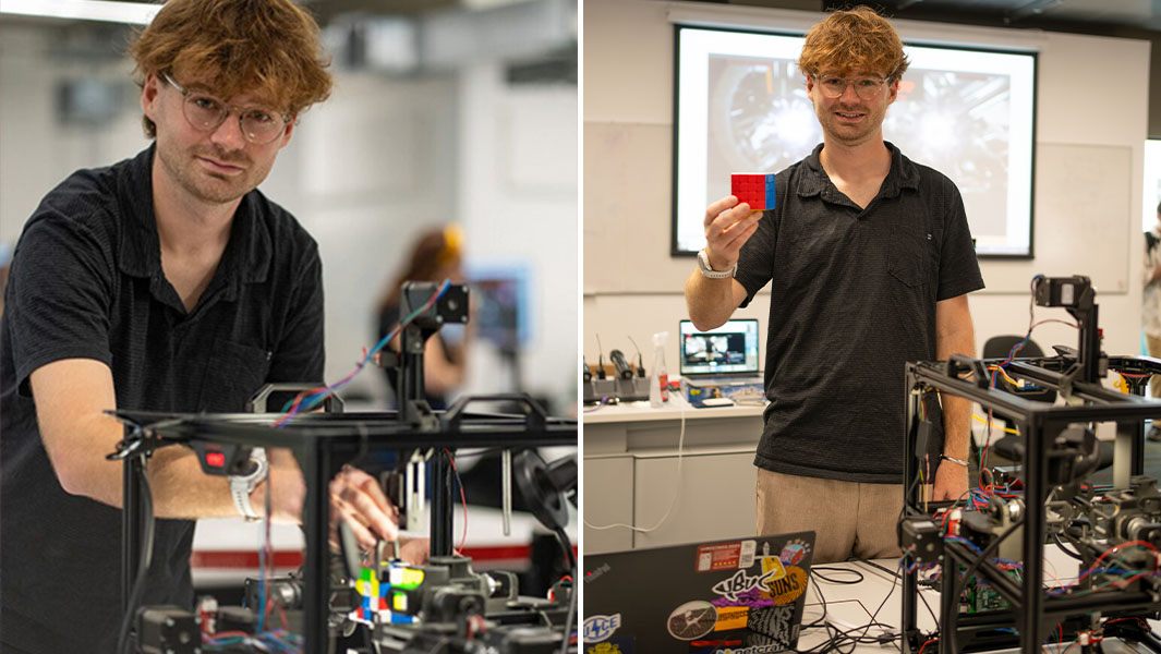 Four robotic arms surrounding colorful puzzle cube solving it at high speed