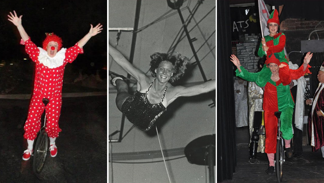 Linda Jarrett in red clown costume and wig riding unicycle on stage during Nutcracker performance
