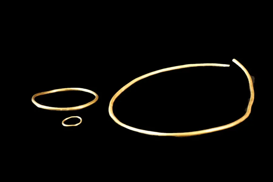 ** Archaeological excavation site showing ancient Celtic tomb discovered near German highway with gold artifacts