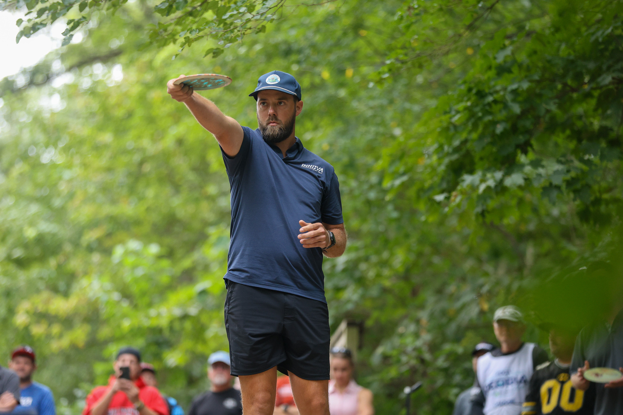 Bradley Williams holding disc golf trophy after winning Masters World Championship title