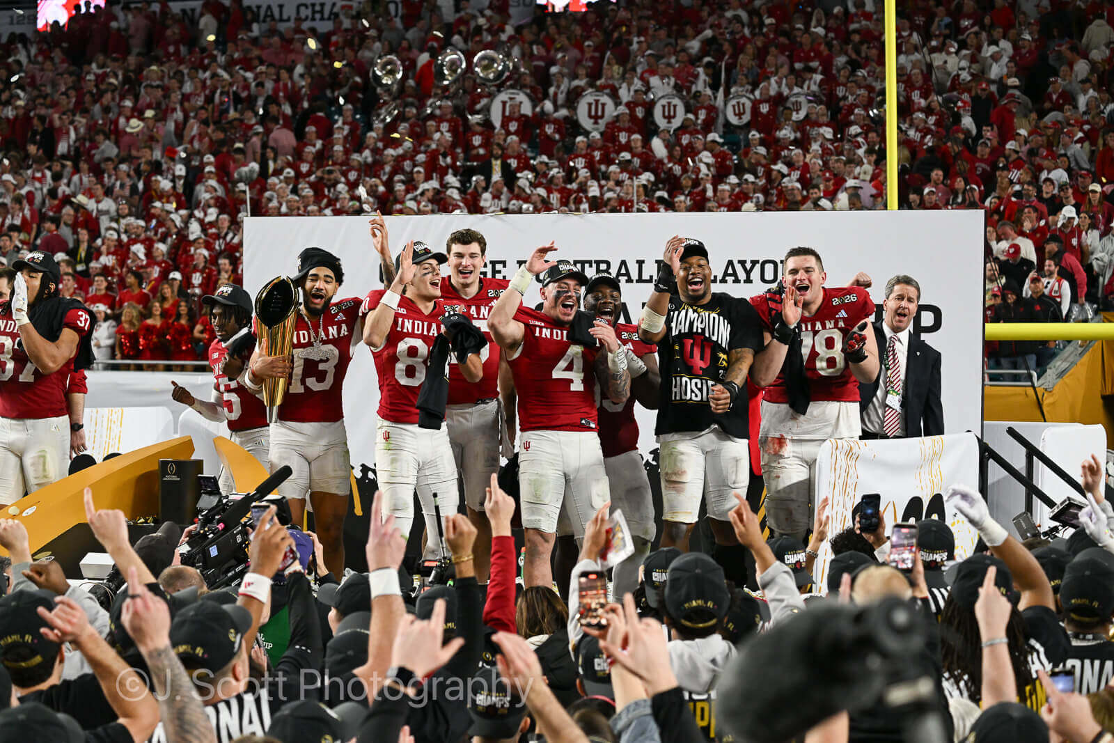 ** Indiana Hoosiers football team celebrating with national championship trophy at Hard Rock Stadium