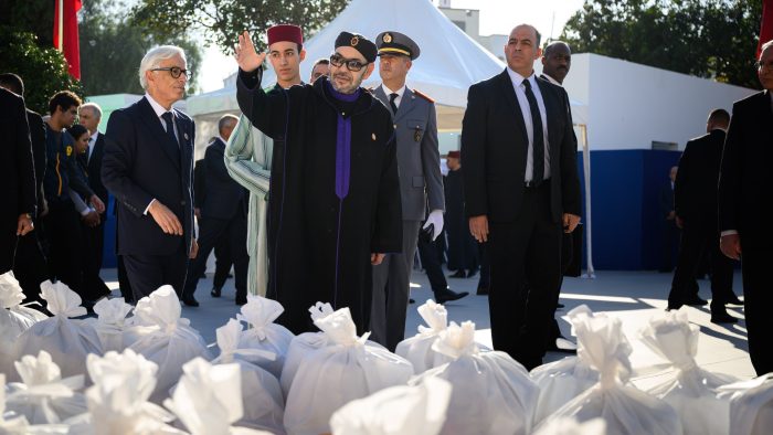 King Mohammed VI and Crown Prince Moulay El Hassan distributing food baskets to Moroccan families