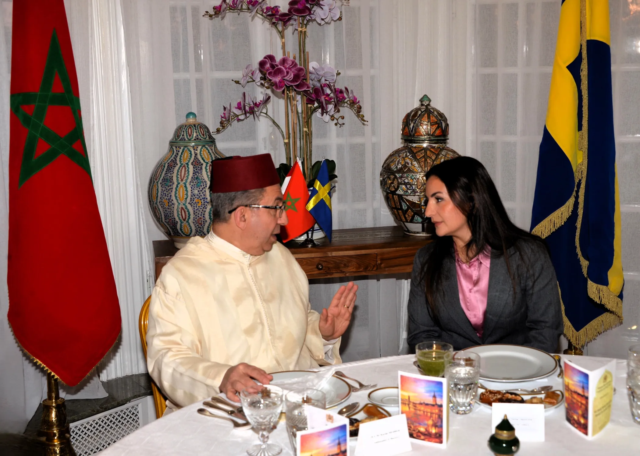 Diverse group of religious and government leaders sharing traditional Ramadan iftar meal at diplomatic residence