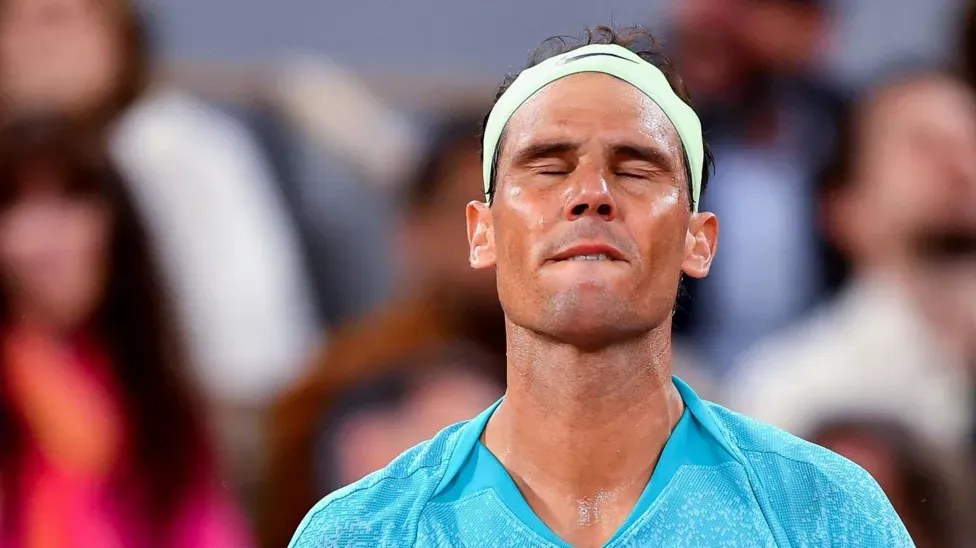 Rafael Nadal holding trophy at French Open tennis tournament, celebrating championship victory