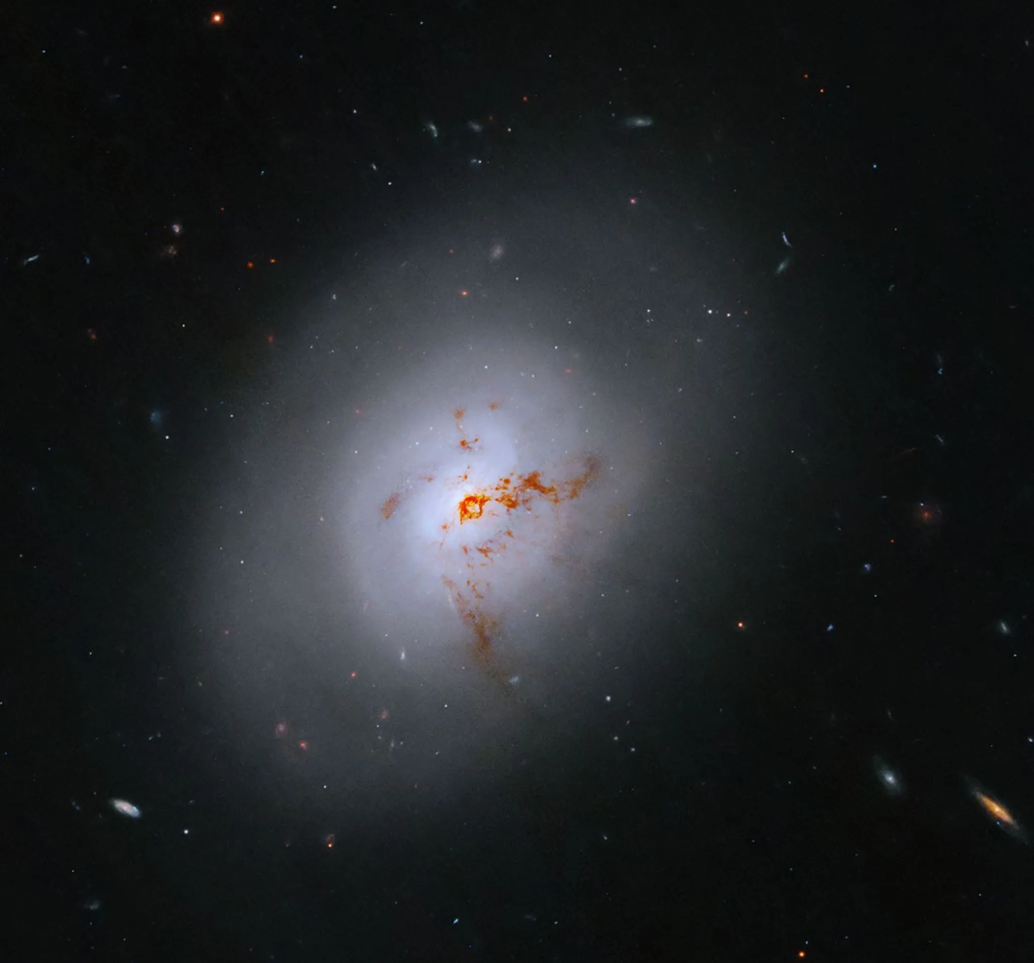 Hubble photograph of lenticular galaxy NGC 1266 with bright center and dusty outer regions