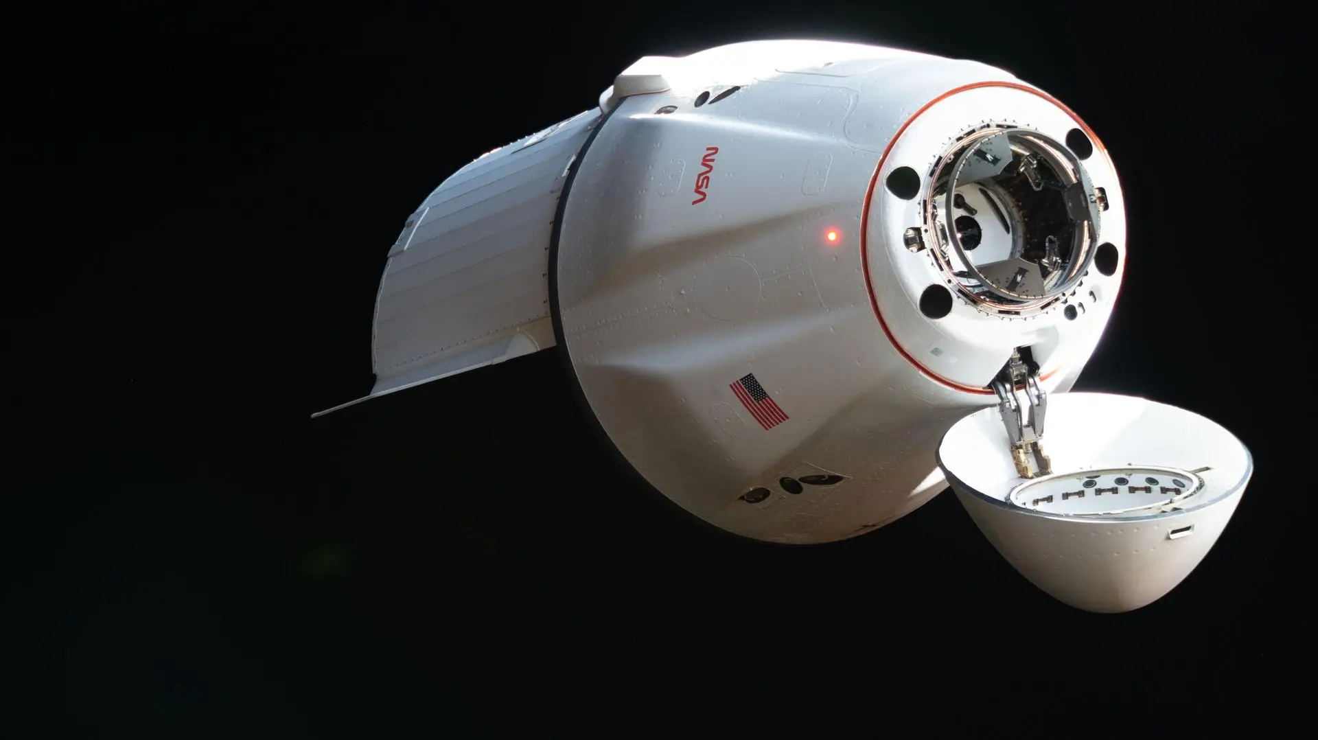 SpaceX Dragon cargo spacecraft approaching International Space Station carrying scientific supplies and equipment