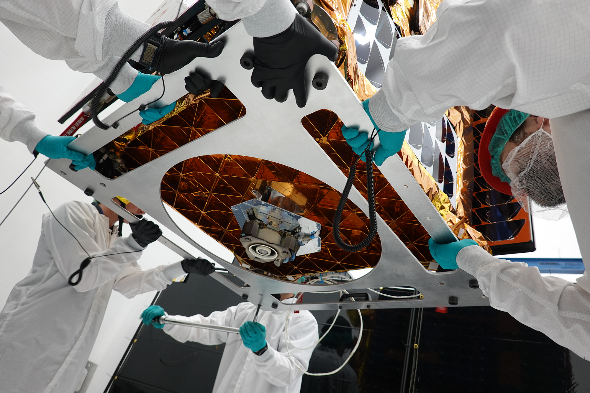 Technicians at Starfish Space prepare the washing machine-sized Otter spacecraft for launch