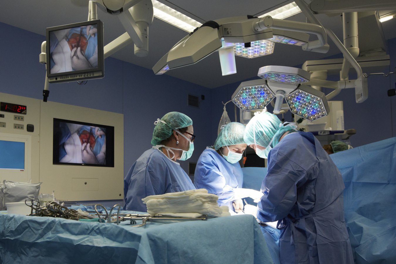 Surgeon performing delicate nerve-sparing procedure during prostate cancer surgery in modern operating room