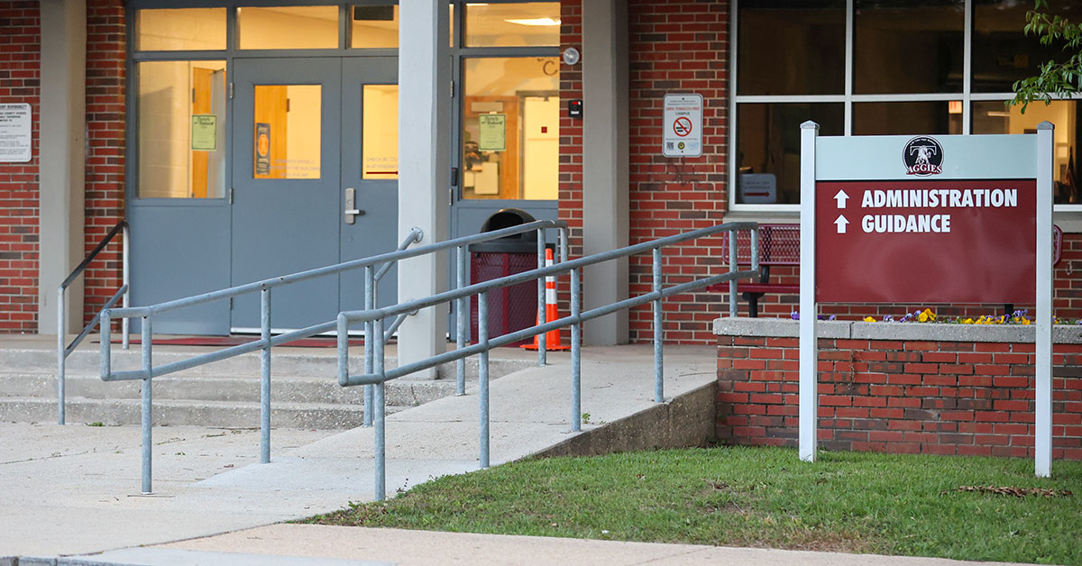 Tate High School building exterior on sunny day celebrating historic achievement