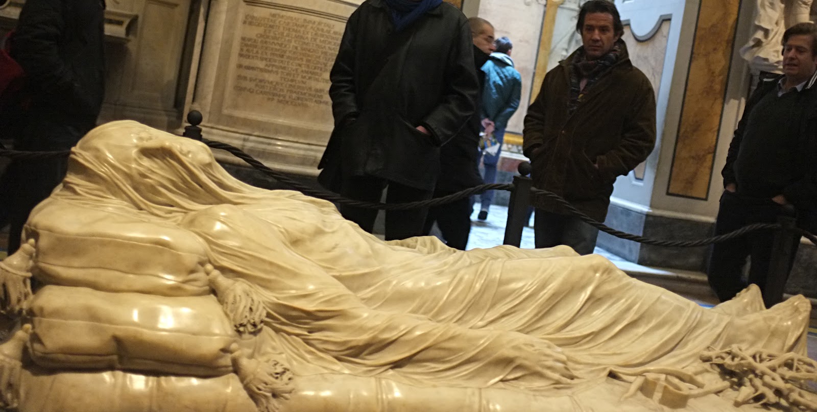 Close view of marble Veiled Christ sculpture showing realistic carved veil over face
