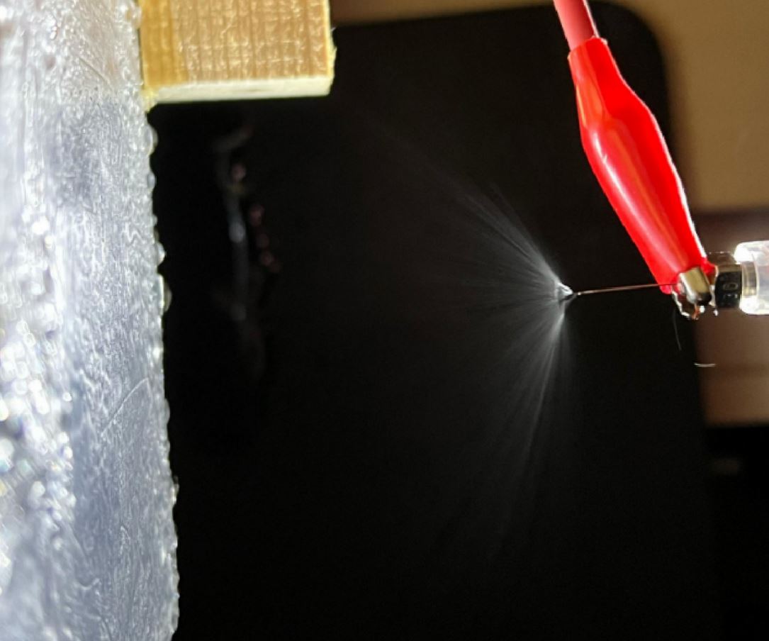 Solar panel with fine water mist cooling system spraying charged droplets across surface