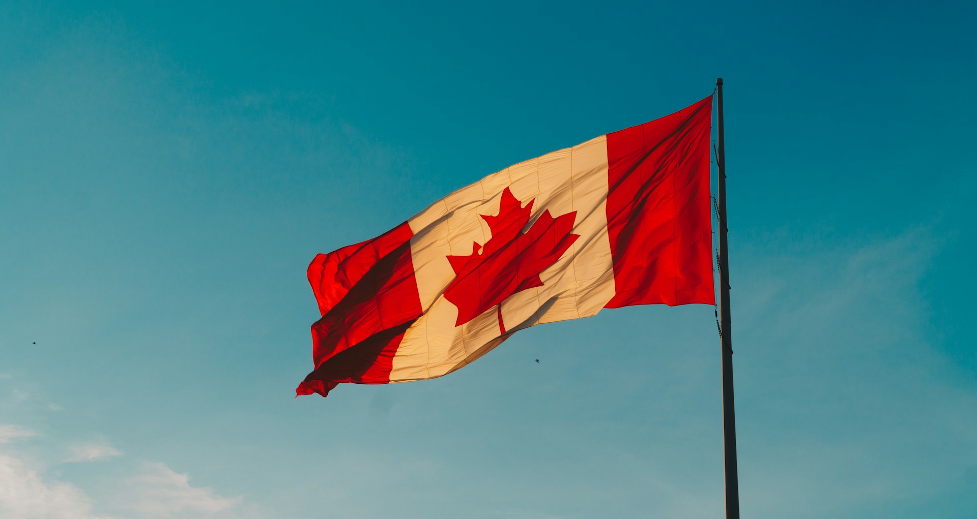 Solar panels installed on residential roof in Canada under bright blue sky