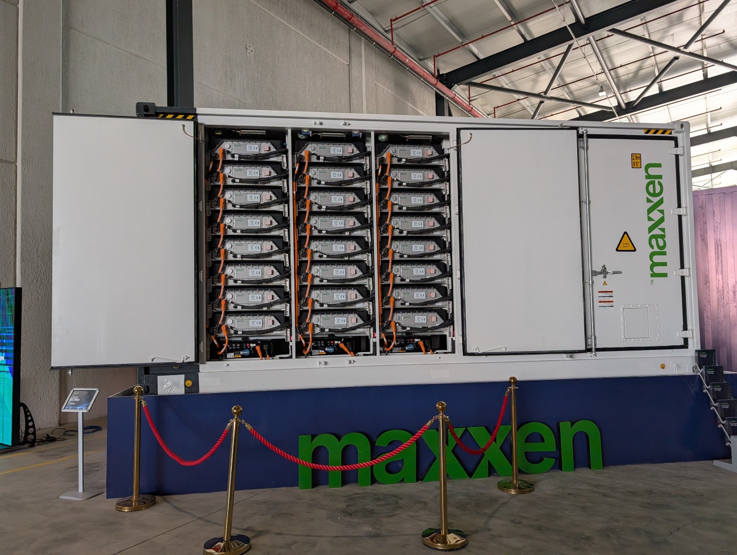 Large white containerized battery storage units inside modern manufacturing facility in Turkey