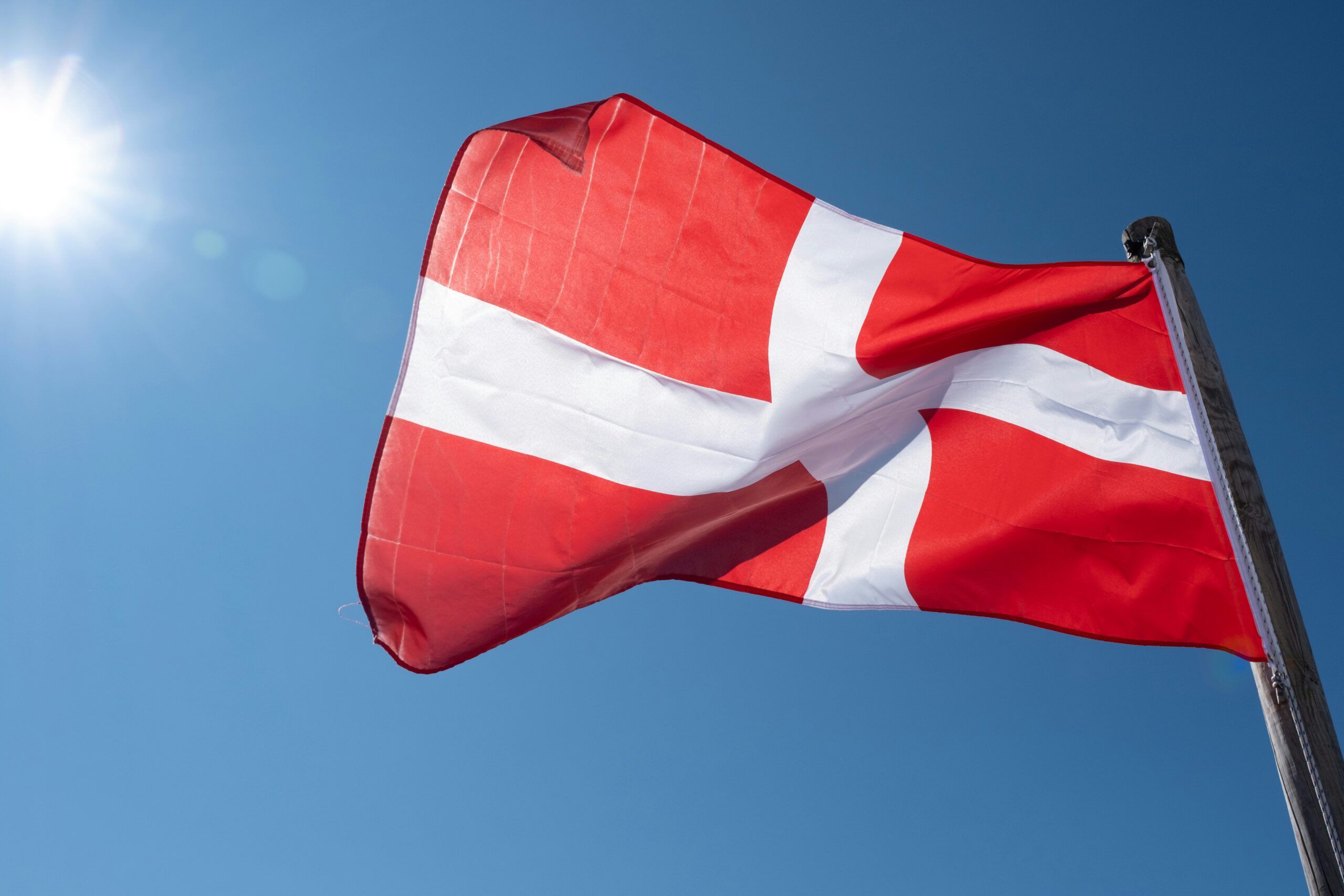 Solar panels installed on red-roofed Danish suburban home with battery storage system