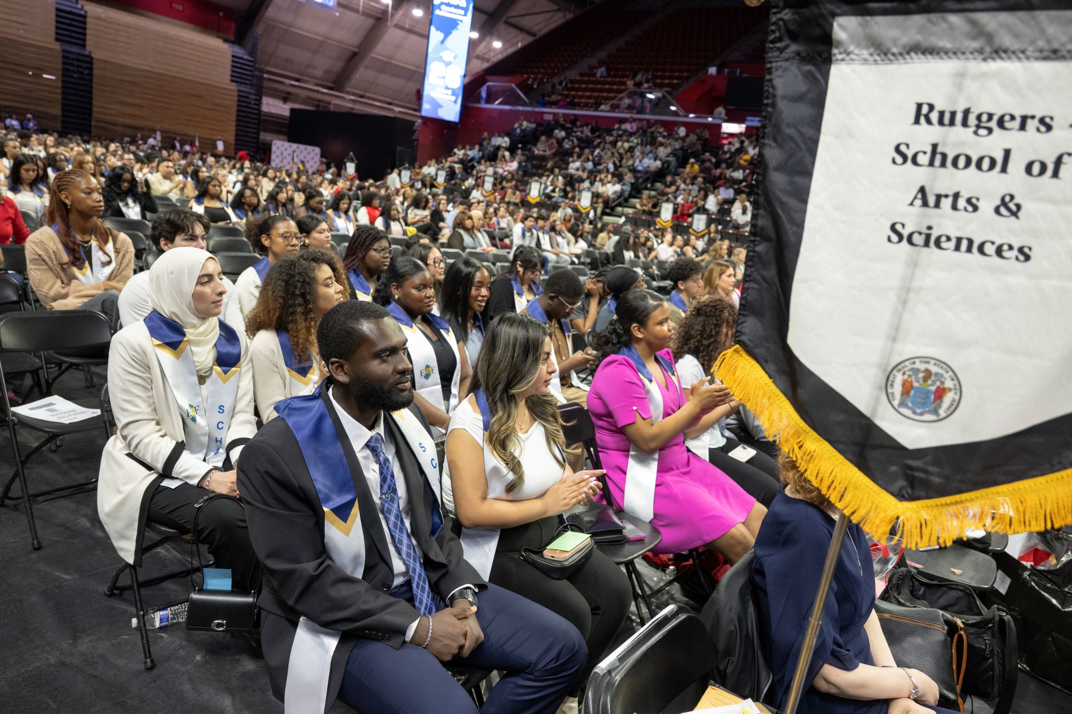 Students in graduation regalia celebrating at EOF Achievement Award Ceremony at Jersey Mike's Arena