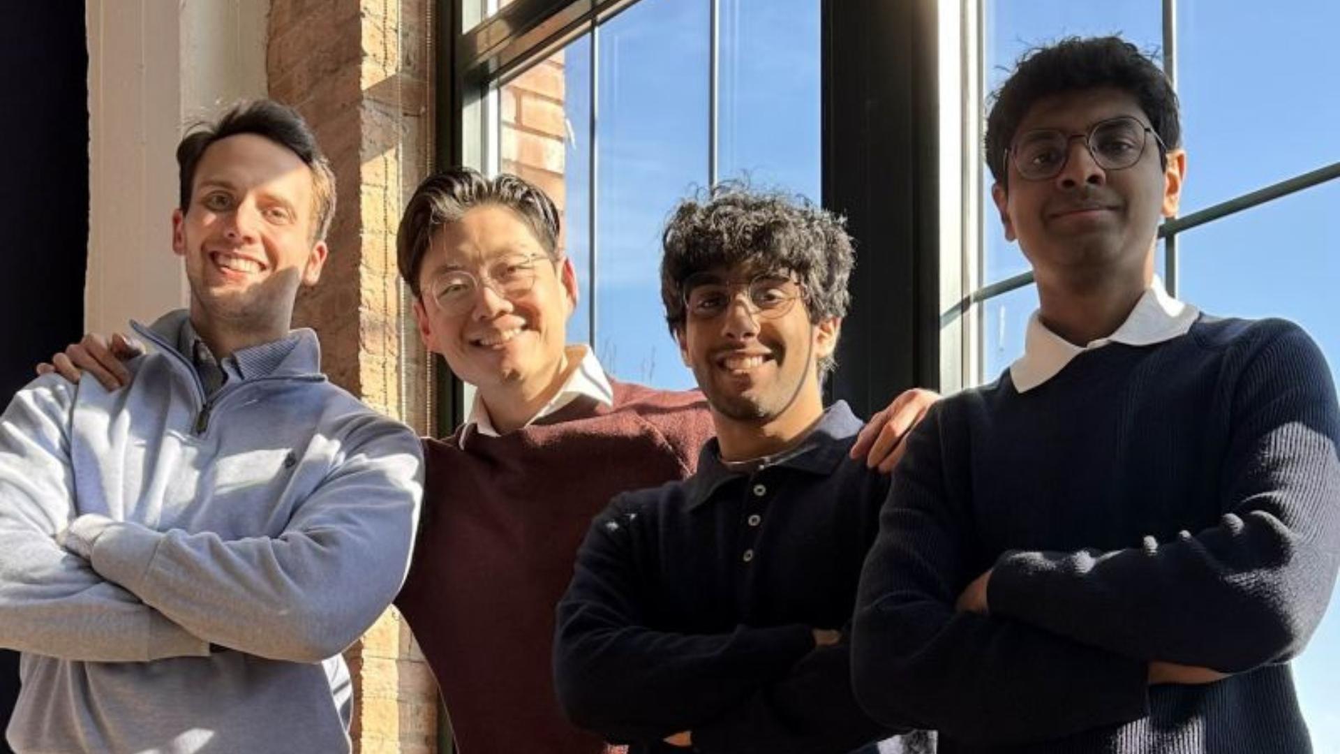 Four Auvi Labs founders standing together in front of window at medical facility