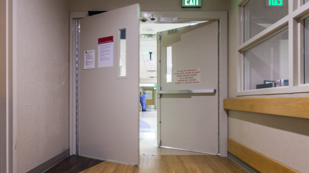 ** Elderly patient with dementia receiving compassionate care from medical staff in hospital emergency room